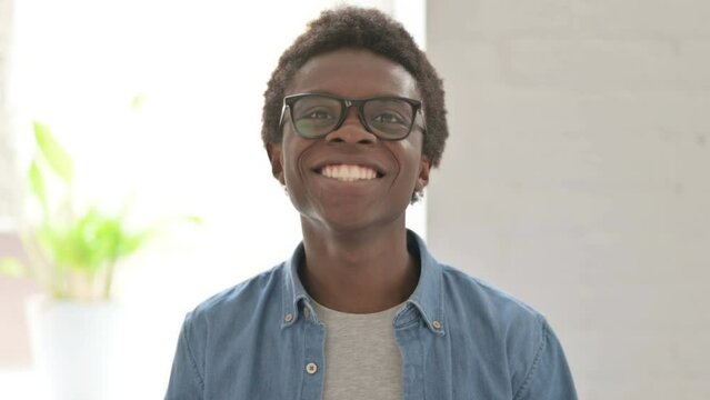 Portrait of Excited Young African Man Celebrating Success 