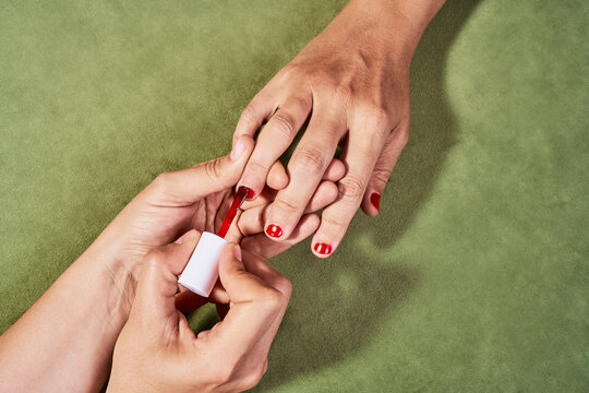 Painting the nails of a transgender person