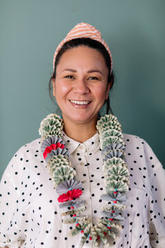 Happy Latin woman with graduation money lei portrait