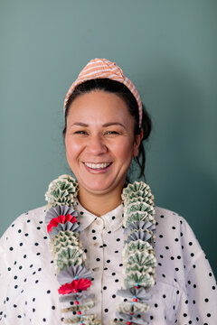 Happy Latin woman with graduation money lei portrait