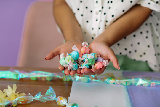 Crop hands holding taffy candies
