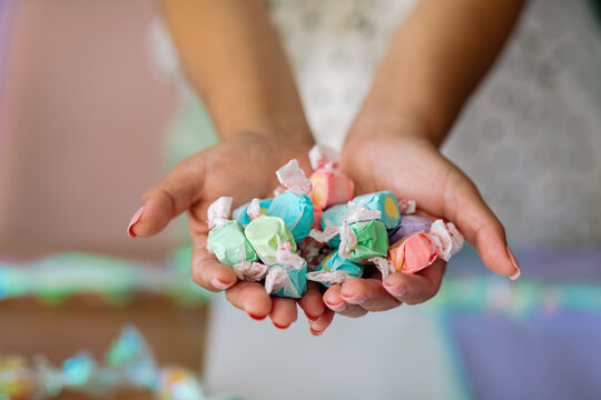 Crop hands holding taffy candies