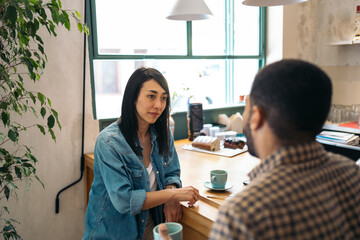 Coworkers having coffee in a cafe after work