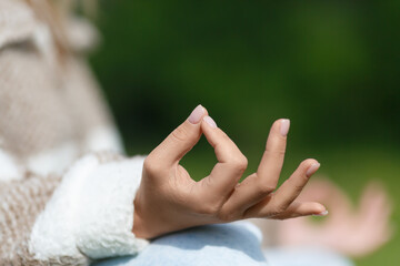 Meditation hands. Female hand durin outdoor meditation.
