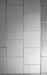 Naklejka premium Old cracked tiled dirty tile texture vertical.Dilapidated old dirty tile wall background.