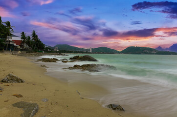 Colourful Skies Sunset over Patong Beach in Phuket island Thailand. Lovely turquoise blue waters, lush green mountains colourful skies and beautiful views of Pa Tong
