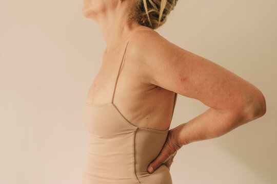 Mature woman in neutral bodysuit