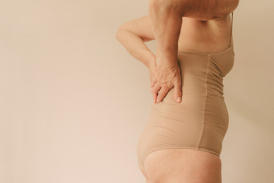 Mature woman in neutral bodysuit