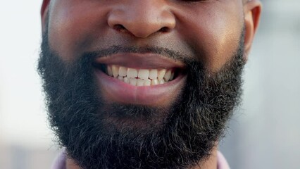 An optimistic young man with a bright smile standing outdoors. The face of a friendly bearded male student smiling outside in an urban town. A hopeful and happy volunteer satisfied with his work