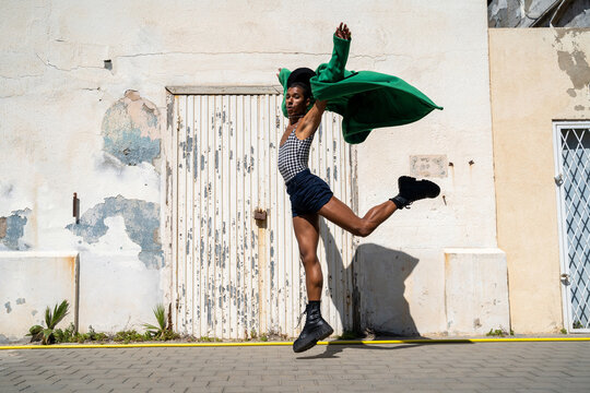 Queer man dancing ballet at street
