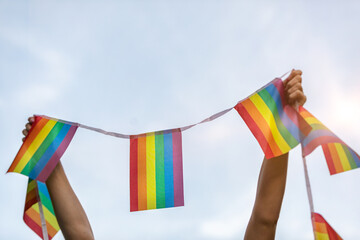 Woman Holding Up LGBTQ+ Pride Flag Banner