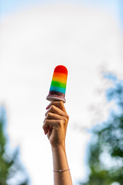 Woman Holds Up Pride Rainbow Popsicle