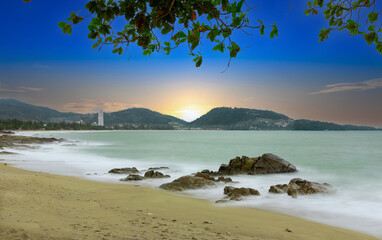 Colourful Skies Sunset over Patong Beach in Phuket island Thailand. Lovely turquoise blue waters, lush green mountains colourful skies and beautiful views of Pa Tong