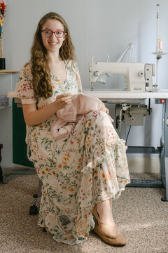 Young seamstress sewing  a dress