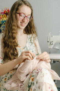 Young seamstress working on a prom dress