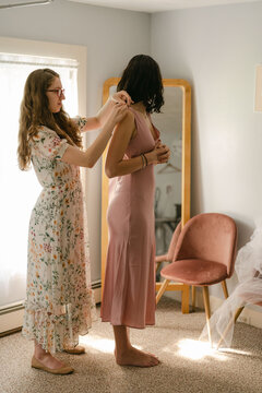 young seamstress woking on  pinning a dress 