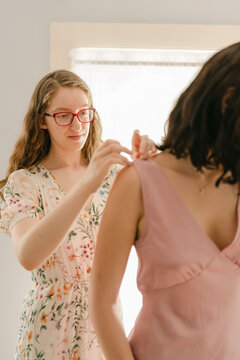 young seamstress pinning a dress 