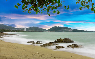 Colourful Skies Sunset over Patong Beach in Phuket island Thailand. Lovely turquoise blue waters, lush green mountains colourful skies and beautiful views of Pa Tong