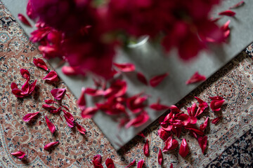 Close-up of a fading bouquet of bright red peonies.