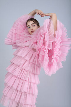 Cute woman in pink ruffle dress