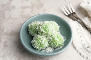 Klepon is Indonesian popular traditional snack, made from glutinous rice flour which is formed into small balls and filled with brown sugar and covered with grated coconut. 