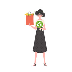 The woman is depicted in full growth and holds a bag of healthy food in her hands and shows the EKO icon. Isolated. Flat trendy style. Vector.