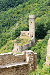 Fototapeta na wymiar Ruins of the castle Philippsburg on a hill spur above Eifel village of Monreal, Germany