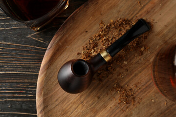 Composition of relaxation with smoking tobacco with smoking pipe, on wooden table
