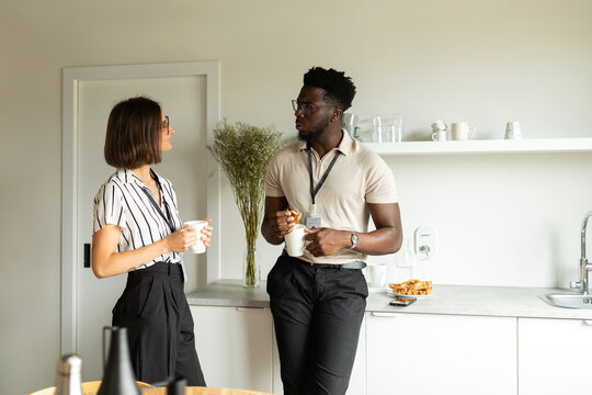 Coworkers taking a break in kitchen office