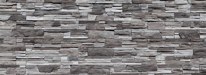 Grey with black texture of brickwork and stone wall for website background or for design, panoramic view