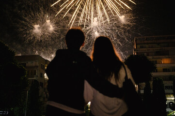 Couple watching and enjoying fireworks display