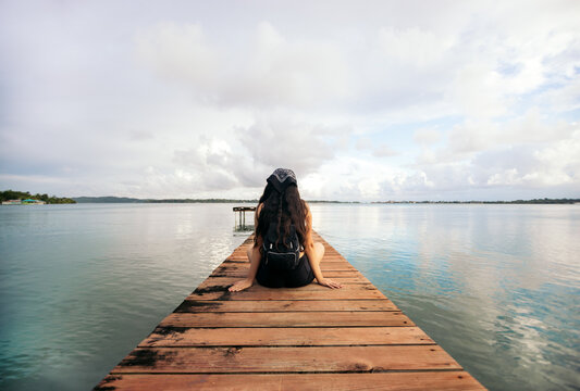 Beautiful shot of a woman alone on a wooden jetty