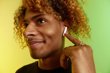 Happy Hispanic man listening to music and dancing