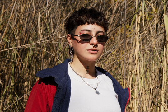 Woman with short hair, glasses and red jacket