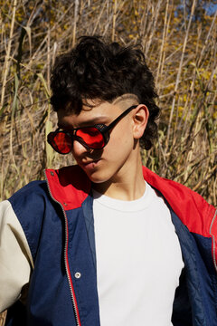 Portrait of very fashionable young man in the park