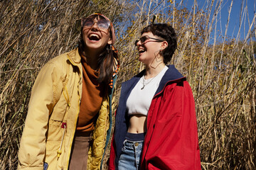 Happy young friends outdoors in park having fun posing
