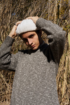 Young man in the park with gray sweater