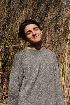 Young man in the park with gray sweater