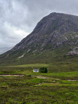 Lone house at bottom of a mountain