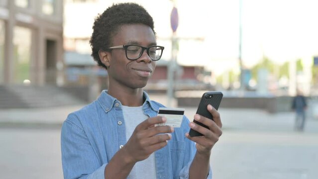 Excited Young African Man Shopping Online via Smartphone, Outdoor