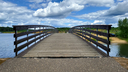 Fototapeta na wymiar Wooden bridge in the park over the lake