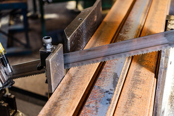 Machine for cutting metal profile. The saw cuts metal blanks into pieces. Industrial equipment for cutting and processing metal.