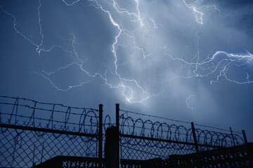 Lightning over fence