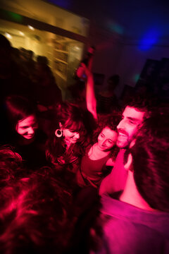 Hugged excited friends having fun together at the party
