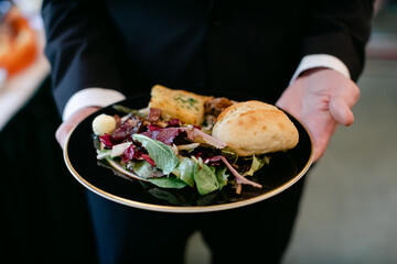 Man Holding Plate of Buffet Food at Wedding