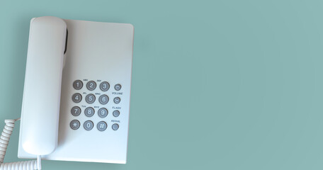 Office telephone isolated on light green background.