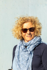  attractive sixty years old woman with blonde curly hair