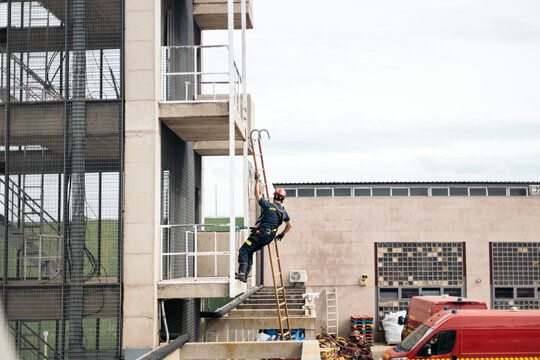Firefighters rappelling at the fire station.