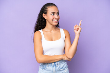 Young woman isolated on purple background pointing up a great idea