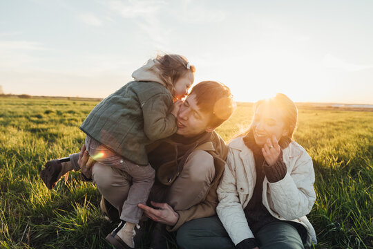 Family on the grass at sunset